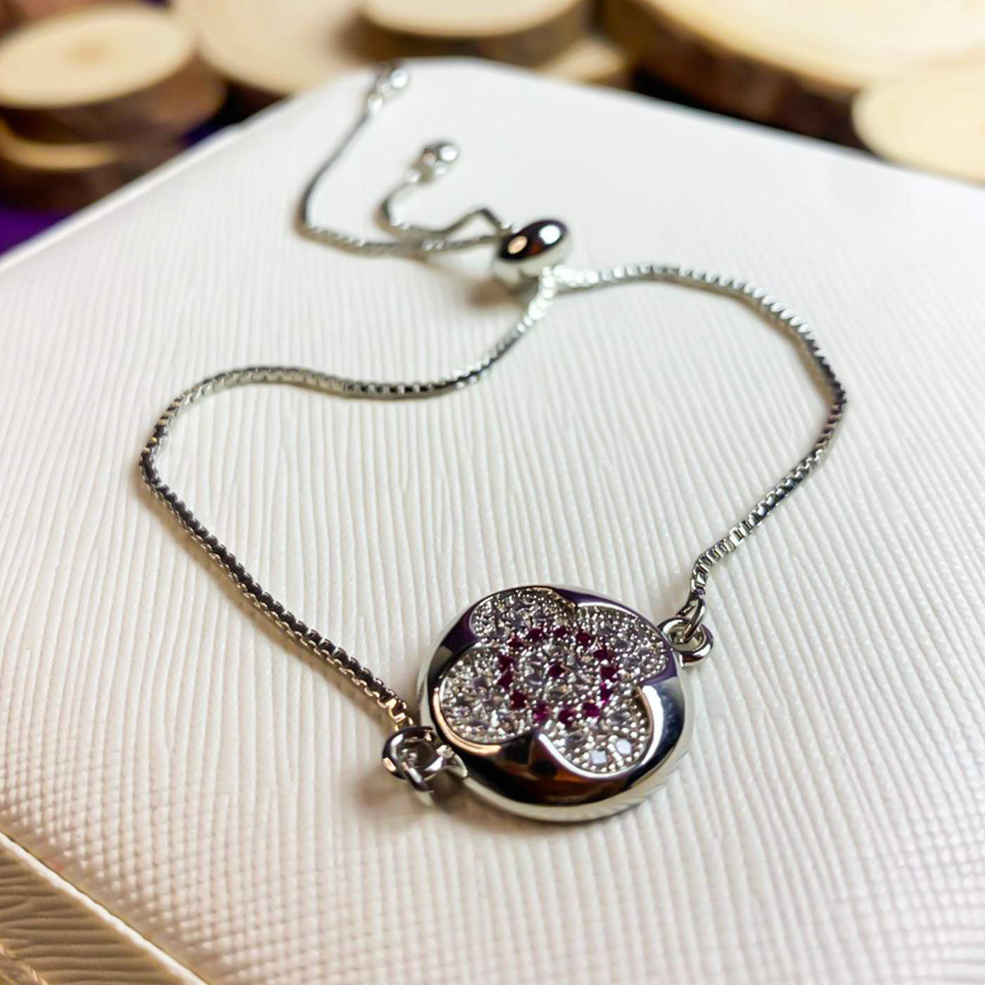 Elegant Silver-Toned Clover Slider Bracelet with Red Zircon